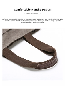 Detail of canvas tote bag with reinforced brown leather handles and heavy-duty stitching