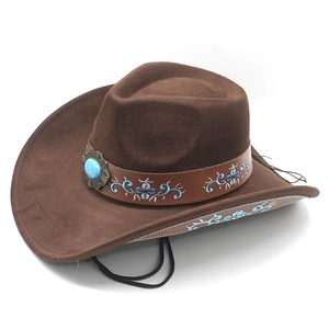 Detail of brown suede cowboy hat featuring blue floral embroidery and turquoise stone