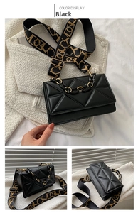 Detail of black crossbody bag with geometric quilting and decorative chunky chain strap