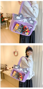 Plush purple tote bag featuring a clear PVC window for doll display and casual outfit view