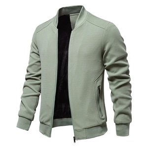 Detail of green waffle texture jacket featuring warm fleece lining and metal zipper closure