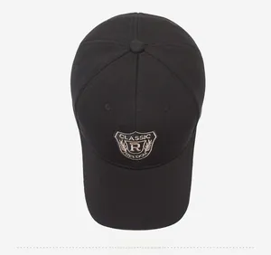 Detail of classic black baseball cap with shield embroidery featuring letter R and text