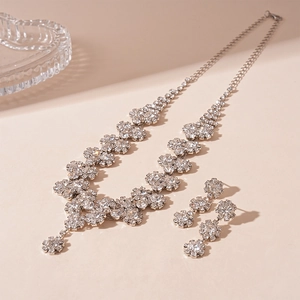 Detailed view of silver rhinestone jewelry set with flower-shaped necklace and earrings