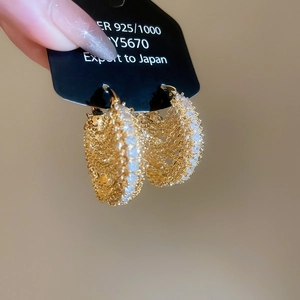Detailed macro view of 18k gold plated chain earrings with sparkling zircon inlay