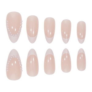French almond press-on nails in nude pink with white tips and pearl accents