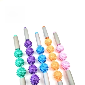 Detail of colorful muscle massage rollers with spiky balls and non-slip handles for yoga
