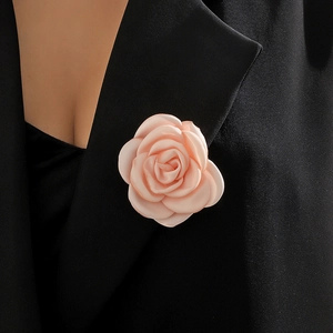 Pink fabric rose brooch pin on black suit lapel with realistic layered petals