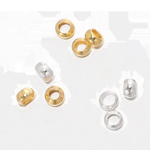 Macro shot of high-shine gold and silver plated metal spacer beads for DIY jewelry making