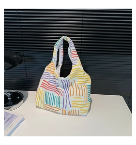 Close-up of a striped colorful tote bag in thick textured corduroy fabric on a table