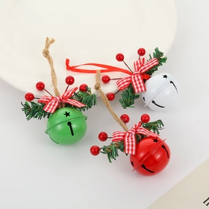Detailed view of red, green and white Christmas bells with pine needles and red berries