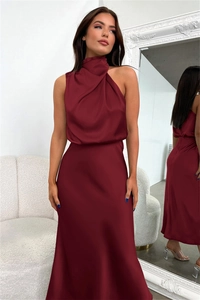 Detailed view of elegant burgundy satin evening gown featuring a halter neck and sleek finish