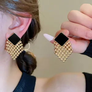 Elegant woven diamond stud earrings with black square enamel and gold bead tassels