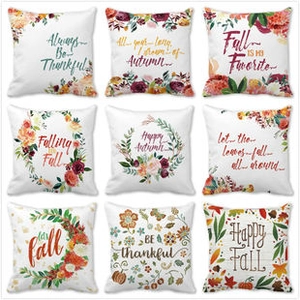 Detail view of nine square peach skin pillow covers with autumn pumpkin and floral patterns