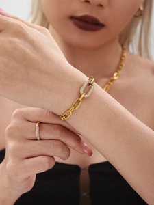 Close-up of a gold-plated link bracelet with micro-pave cubic zirconia on female wrist