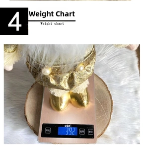 Macro shot of a golden plush Christmas Santa doll showing weight on a scale