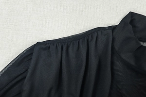 Detail of gathered shoulder and stand collar on elegant black ruched summer dress