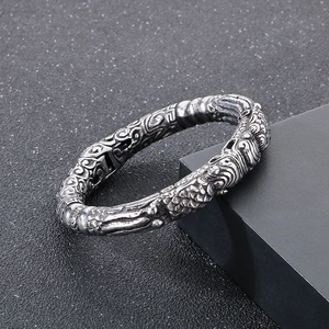 Retro silver Pixiu cuff bracelet with auspicious cloud patterns in a 45-degree side view