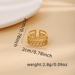 Detailed view of golden open ring featuring a star charm and intricate lace texture