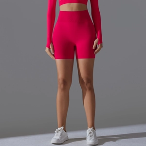 Close-up of seamless fuchsia high-waisted yoga shorts with wide tummy control waistband