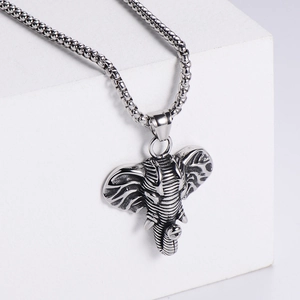 Detailed view of silver stainless steel elephant head pendant on a box chain
