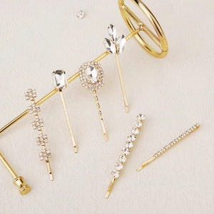 Golden metal hair clip set with sparkling clear crystals in 6 different elegant styles