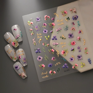 Detail of floral nail stickers with gold foil lettering and 3D embossed flower patterns