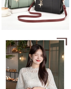 Detail view of stylish green and black handbags with metal pendants and wine red strap