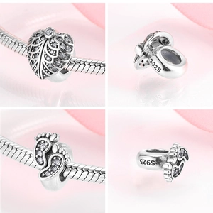 Macro detail of S925 sterling silver heart and baby footprint charms for DIY bracelets
