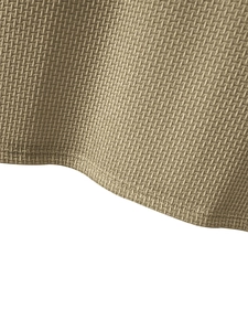 Close-up of khaki breathable waffle knit fabric texture on men's fitted running t-shirt