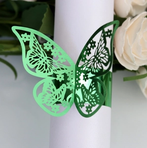 Detailed view of laser-cut green metallic butterfly napkin ring for table decor