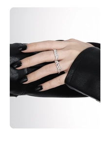 Macro shot of silver thorn texture rings on model with black leather background