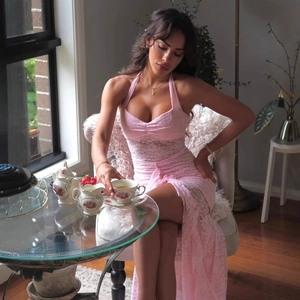 Close-up of pink lace stitching and sheer detail on halter neck slim maxi dress