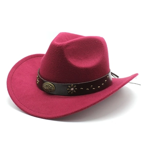 Detail of dark red felt cowboy hat featuring vintage metal studs on a brown faux leather band