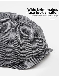 Detail of herringbone newsboy cap featuring top button and wide brim texture