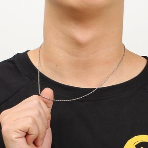 Close-up of stainless steel bead chain necklace worn by a model on white background