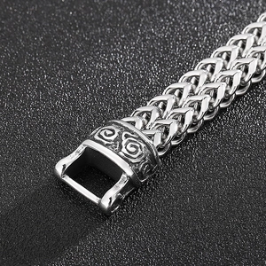 Detailed macro view of the punk dragon scale chain and engraved silver metal clasp