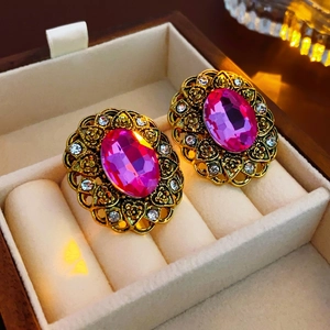 Vintage style gold oval earrings with pink crystal and hollow flower patterns