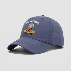 Detail of embroidered skateboarding dinosaur and laser-cut breathability holes on kids cap