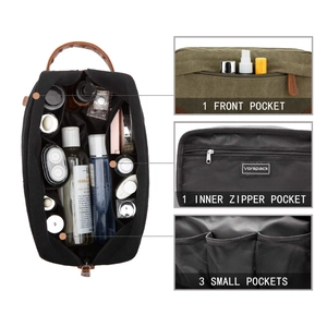 Detailed view showing internal zipper and small pockets in a canvas men's toiletry bag