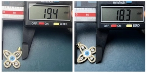 Detailed measurement of gold butterfly evil eye pendant with shell inlay using digital caliper