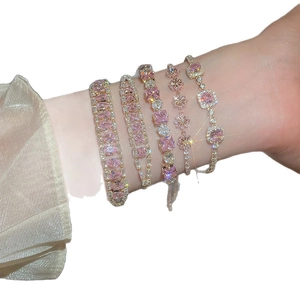 Minimalist adjustable gold bracelets set featuring pink crystal geometric flower charms