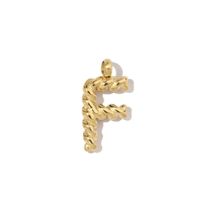 Macro detail of gold 18k plated titanium steel letter F pendant with twisted rope texture