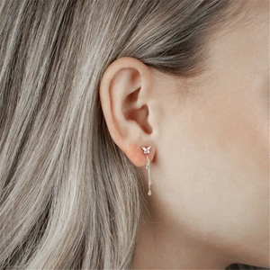 Detail of s925 silver butterfly tassel earrings with sparkling white zircons on ear
