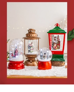Detailed view of assorted Christmas snow globe lanterns with Santa and snowman figures