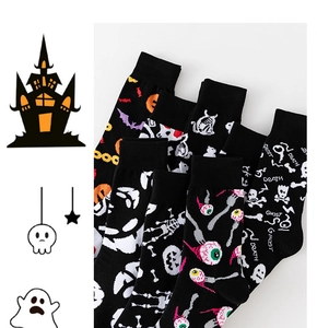 Detailed view of Halloween crew socks featuring patterns of pumpkins, ghosts, and skulls