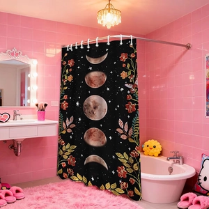 Detail of moon phase shower curtain with floral patterns in a pink bathroom setting