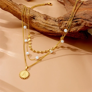 Three-layer gold titanium steel necklace with white pearls and a letter A coin pendant