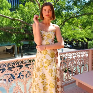 Floral print V-neck backless sundress with thin straps and a flowy fit in cream and brown