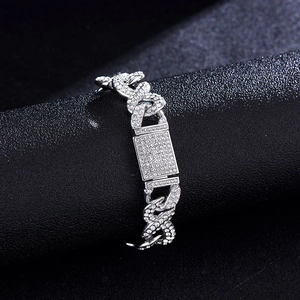 Detailed macro view of silver Cuban chain bracelet with sparkling crystal rhinestones