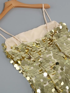 Detail of gold large sequins and adjustable straps on a shimmering party evening dress